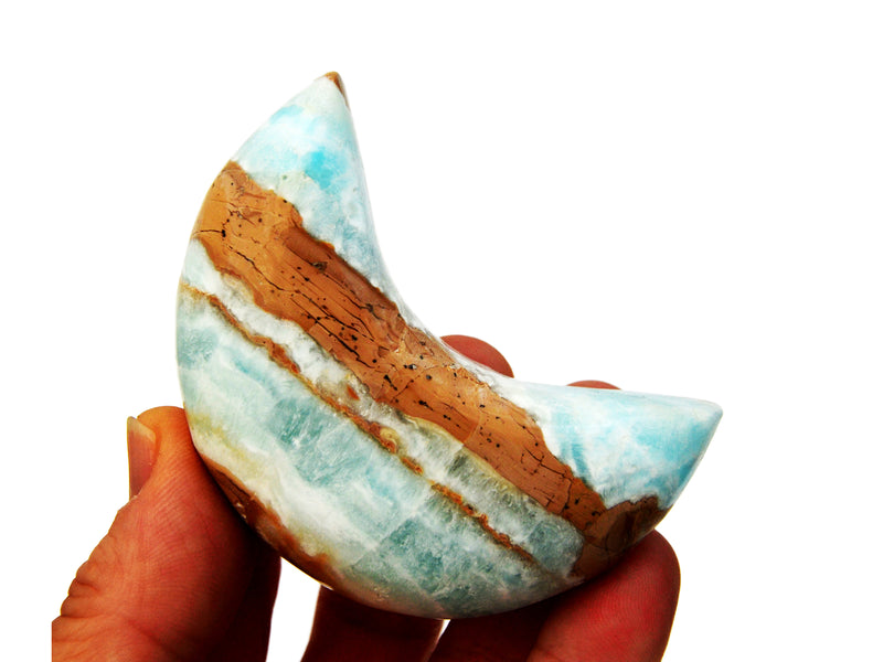 One blue caribbean calcite moon stone 75mm on hand with white background