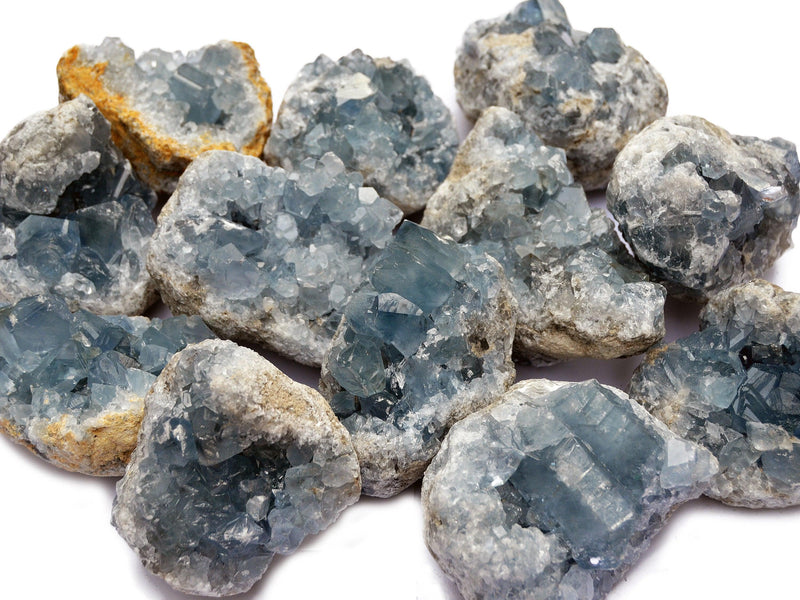 Several celestite crystal clusters on white background