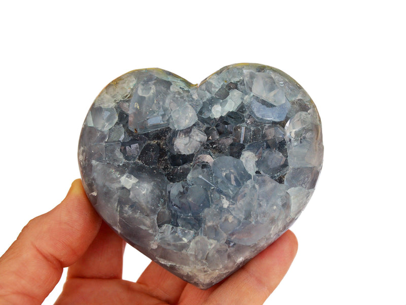One large celestite druzy heart on hand with white background