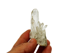One mini clear quartz cluster 40mm on hand with white background