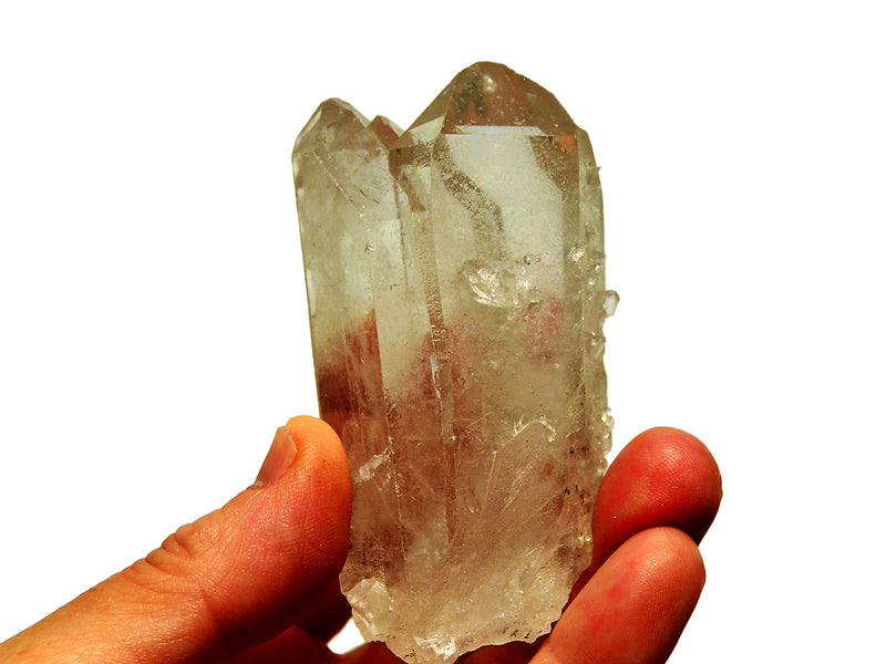Clear quartz triple point held between fingers against a white background