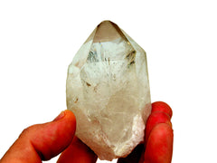 Raw clear quartz point 80mm on hand with white background