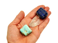 Blue aragonite tumbled, raw clear quartz point and lapis lazuli tumbled 20mm-30mm on hand with white background