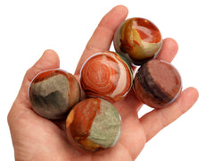 Five desert jasper crystal sphere 25mm-40mm on hand with white background