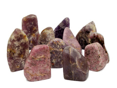 Some purple lepidolite free form crystals on white background