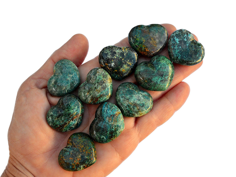Ten green chrysocolla stone hearts 30mm on hand with white background