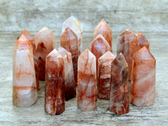 Several fire quartz tower crystals on wood table