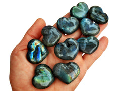 Ten labradorite heart crystals 30mm on hand with white background