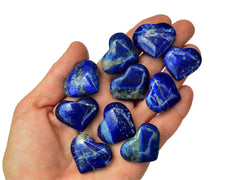 Ten lapis lazuli crystal hearts 30mm-35mm on hand with white background