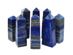 Several blue lapis lazuli crystal towers 100mm-140mm on white background