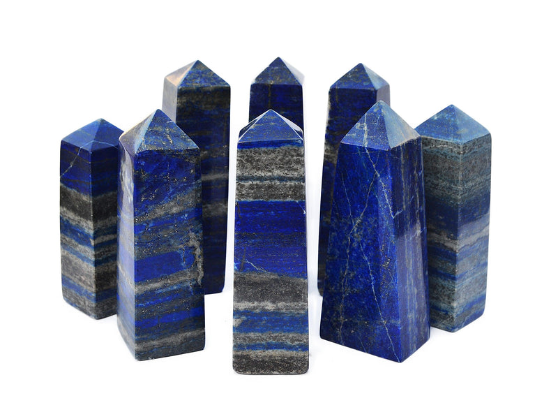 Several natural blue lapis lazuli tower stones 85mm-140mm on white background