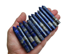 Lapis lazuli mini crystal points 60mm-65mm on hand with white background