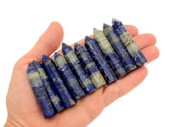 Ten lapis lazuli mini points 50mm-55mm on hand with white background
