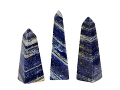 Three lapis lazuli obelisks 85mm-175mm on white background
