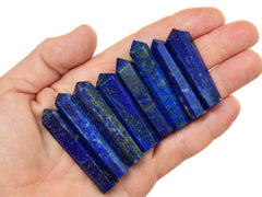 Eight blue lapis lazuli tower points 45mm-50mm on hand with white background