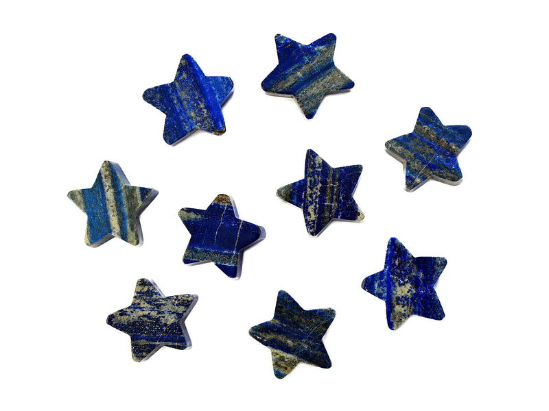 Several blue lapis lazuli moon crystals 60mm on white background