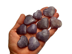 Ten lepidolite crystal hearts 25mm-35mm on hand with white background