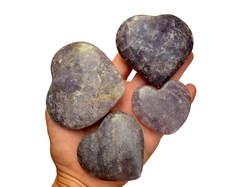 Four purple lepidolite heart crystals 45mm-70mm on hand with white background