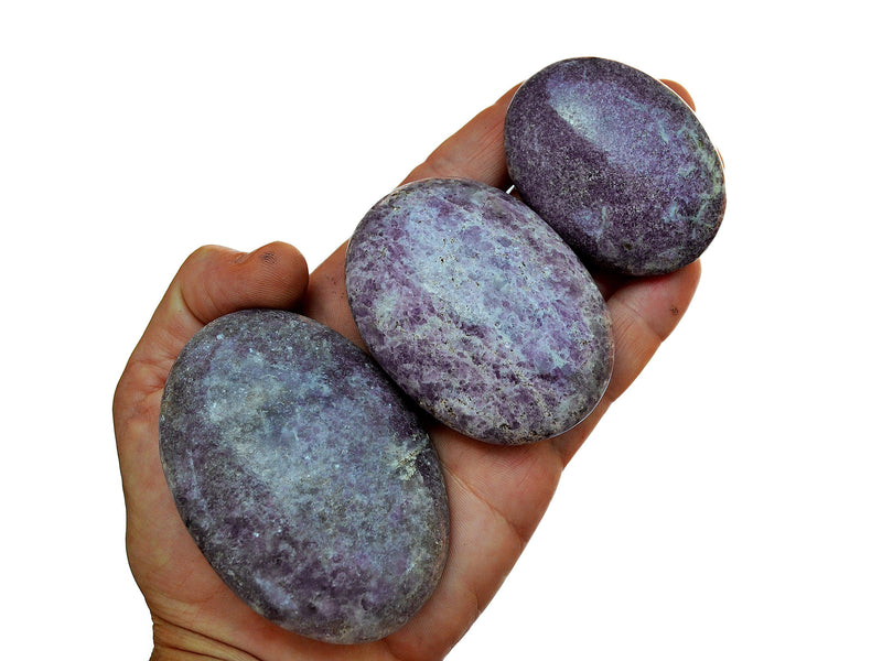 Three purple lepidolite palm stones 45mm-90mm on hand with white background