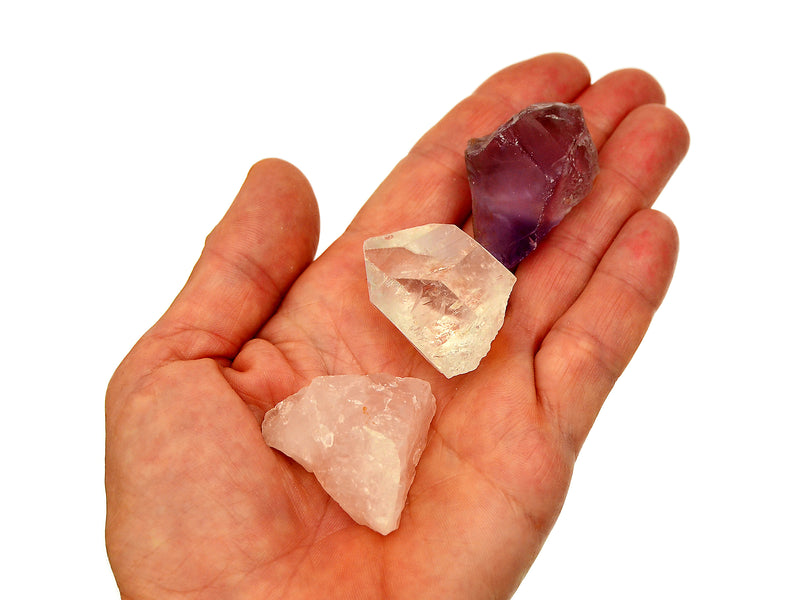 Raw amethyst, clear quartz point and rose quartz crystal 30mm-40mm on hand with white background