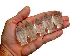 Four mini clear quartz buddha head figures 35mm-40mm on hand with white background