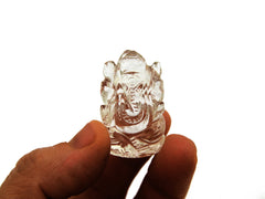 One mini clear quartz ganesha sculpture 30mm on hand with white background