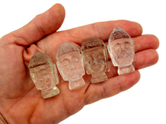 Four mini clear quartz buddha head sculptures 35mm-40mm on hand with white background