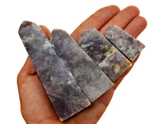 Four purple lepidolite crystal obelisks 40mm-105mm on white background