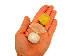 Yellow calcite tumbled, raw clear quartz point and tumbled mangano calcite 20mm-30mm on hand with white background