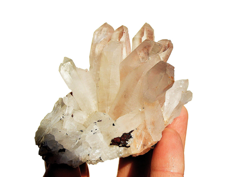 Rough crystal quartz cluster on hand with white background