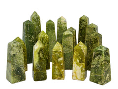 Several green serpentine obelisks stones 60mm-130mm on white background