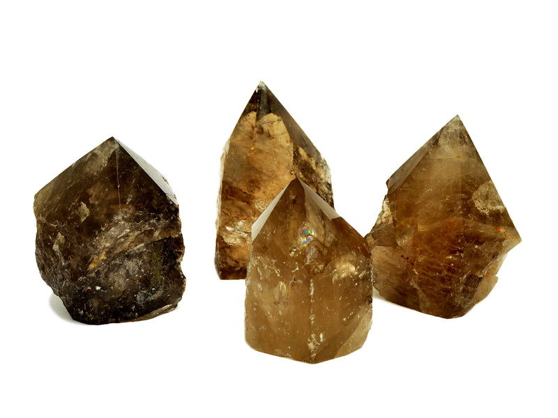 Four semi polished smoky quartz points 65mm-90mm on white background
