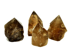 Four semi polished smoky quartz points 65mm-90mm on white background