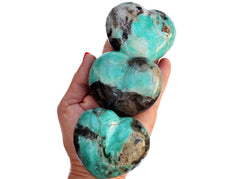 Three large green amazonite heart crystals 70mm on hand