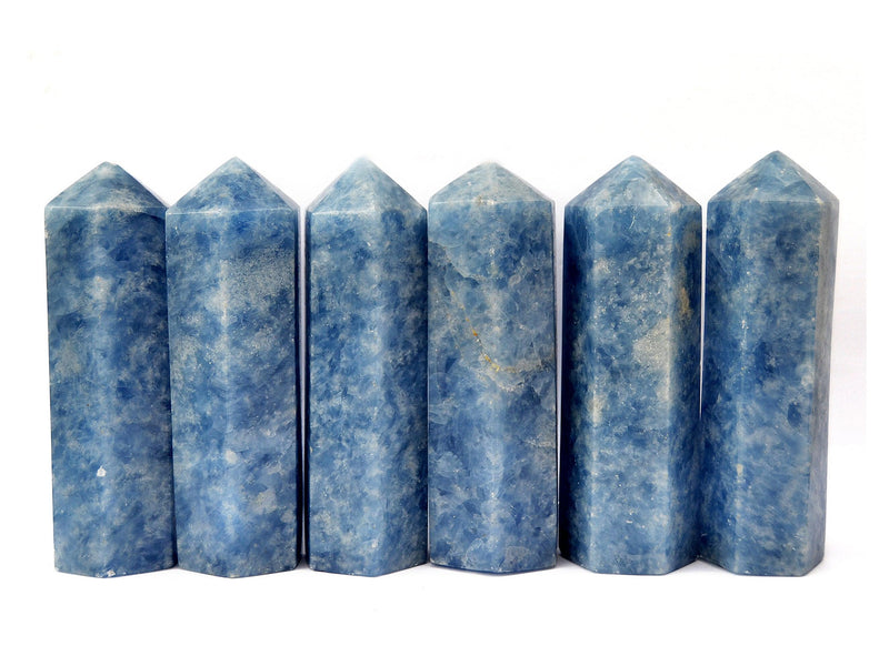 Six large blue calcite crystal obelisks 110mm on white background