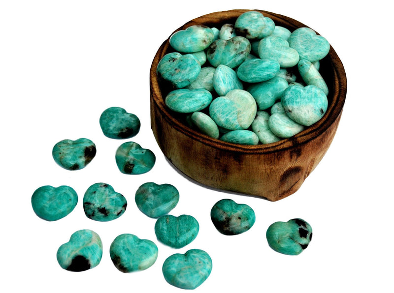 Several amazonite heart stones 30mm inside a bowl and some crystals outside on white background