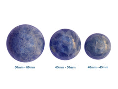 Three blue calcite sphere stones 60mm - 40mm on white background