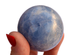One large blue calcite crystal ball 60mm on hand