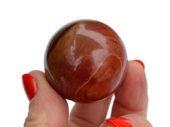 Polychrome jasper crystal sphere stone 35mm on hand