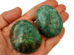 Two green chrysocolla palm stone crystals on hand