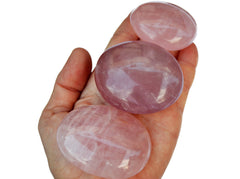 Three pink quartz palm stones 70mm-40mm on hand