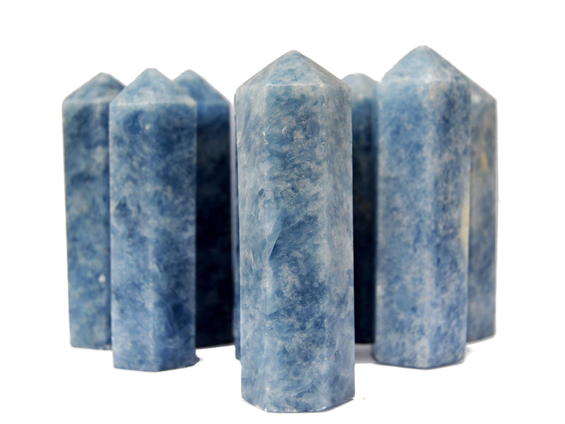 Some large blue calcite crystal obelisks 110mm on white background