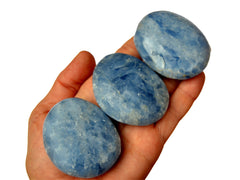 Three blue calcite palm stones on hand