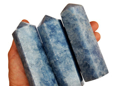 Three large blue calcite crystal towers 110mm on hand