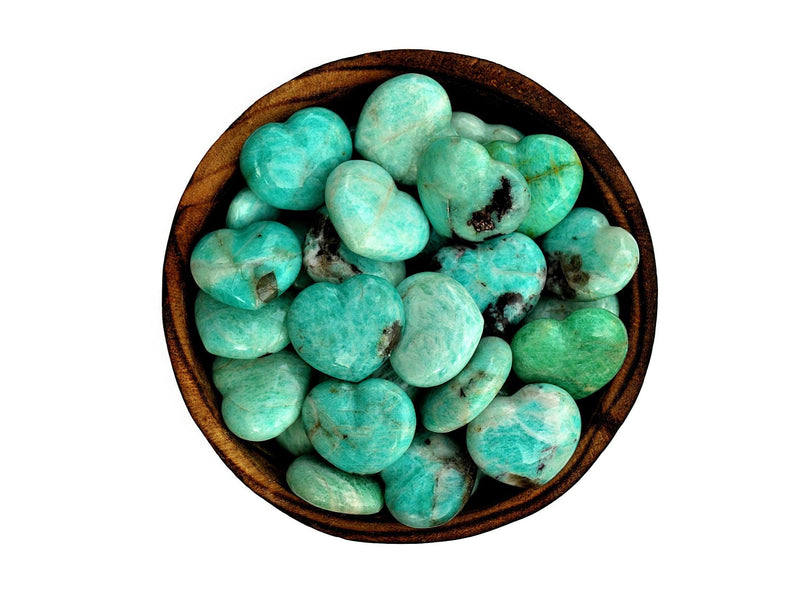 Several small green amazonite crystal hearts 30mm inside a wood bowl