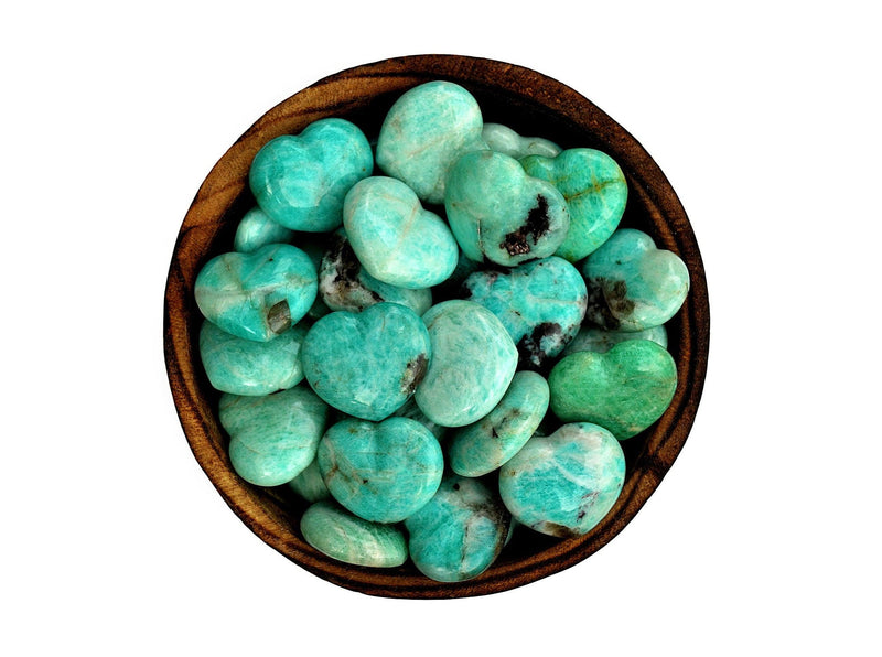 Several amazonite crystal hearts 30mm inside a bowl  on white background