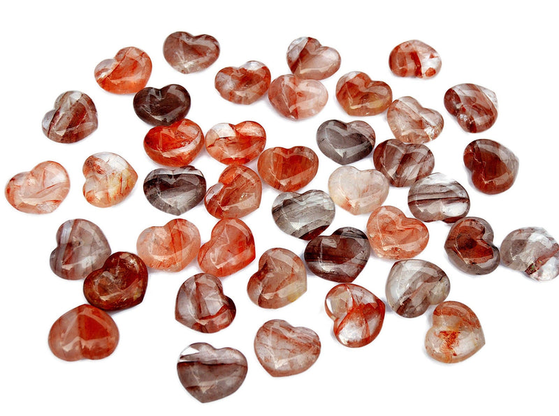 Several fire quartz puffy heart stones 30mm on white background