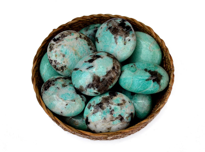 Several green amzonite palm stones 40mm-60mm inside a basket