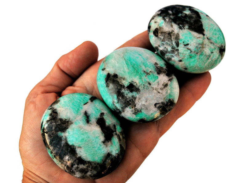 Three amazonite palm stone crystals 40mm-50mm on hand with white background