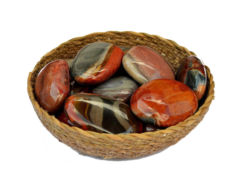 Several polychrome jasper palm stones 40mm-70mm inside a basket